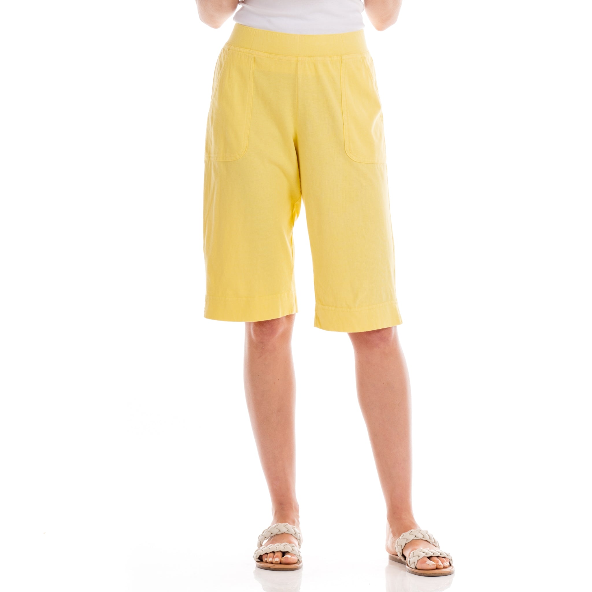 A person is wearing Fresh Produce Clothes’ Key Largo Pedal Pushers in Daffodil-Lagoon paired with a white cotton jersey top and white sandals, standing against a white background. The image is cropped at the shoulders.